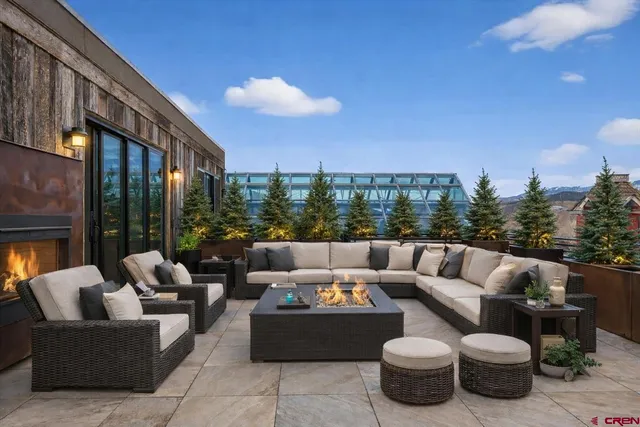 a balcony with furniture and a potted plant