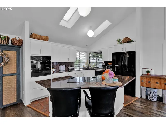 a kitchen with a dining table and chairs