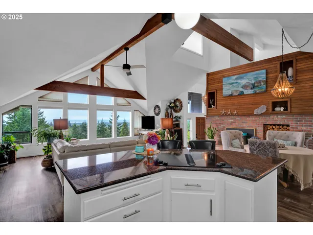 a kitchen area with granite countertop a sink and a large mirror