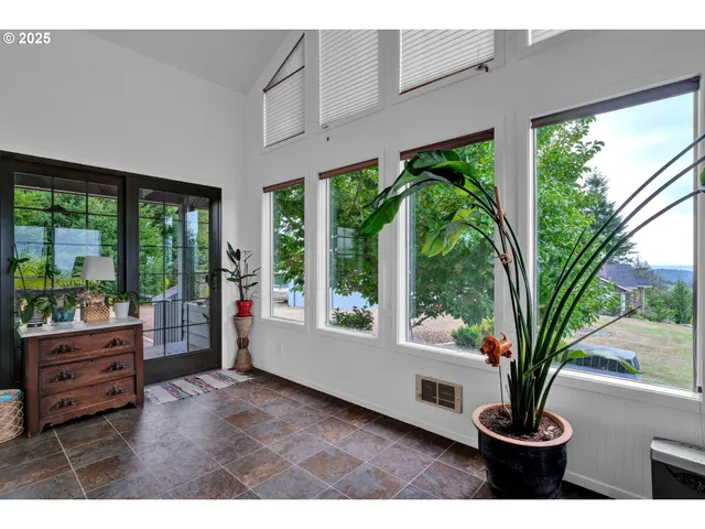 a living room with furniture and large windows