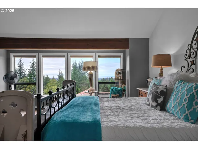 a living room with a floor to ceiling window and a flat screen tv