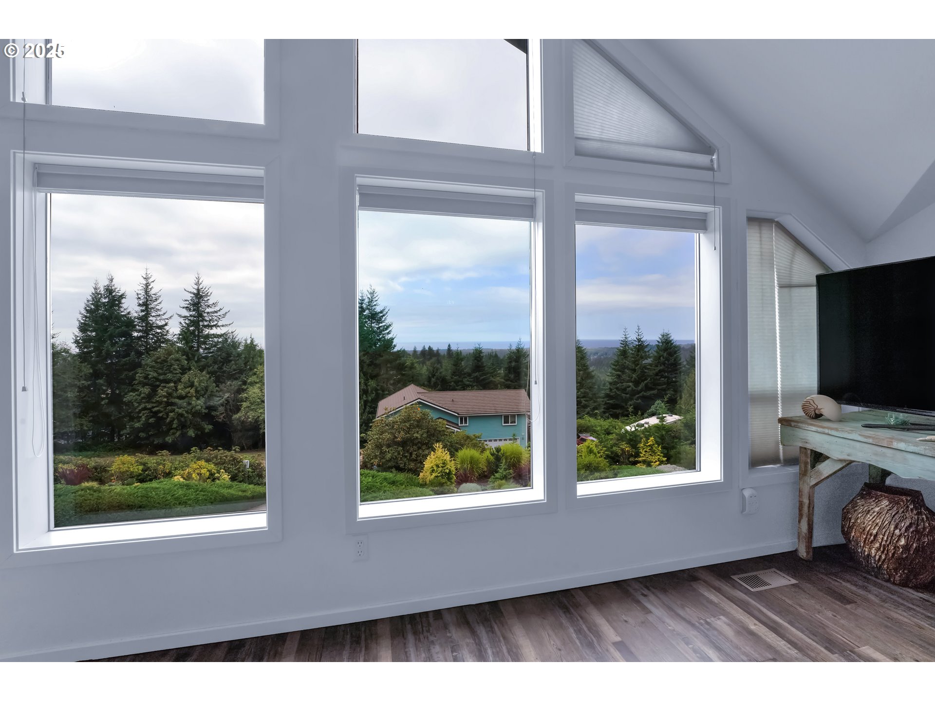 88616 Ocean View Lane Florence, OR 97439 - Photo 6 of 47 a living room with a large window and a flat screen tv