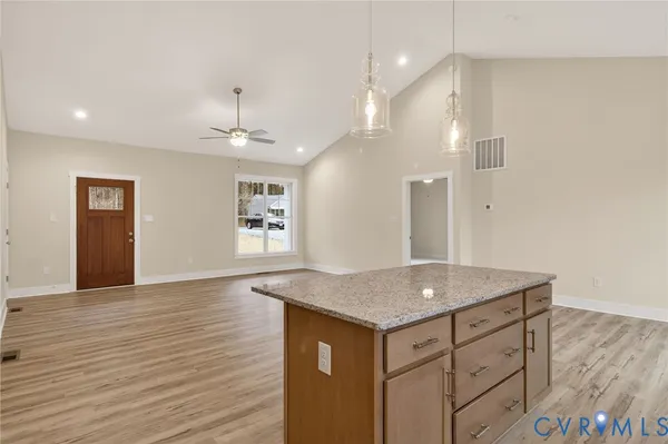 a kitchen with a granite countertop sink and refrigerator