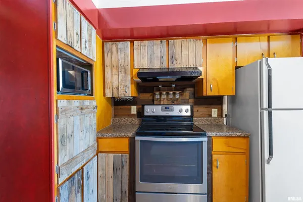 a kitchen with a refrigerator and a stove