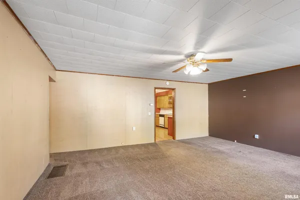 a view of a livingroom with a ceiling fan and window