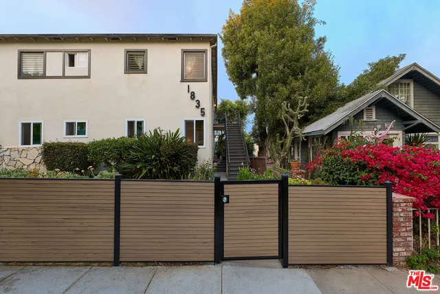 a view of a house with wooden fence