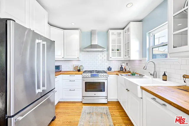 a kitchen with stainless steel appliances granite countertop a stove and a refrigerator