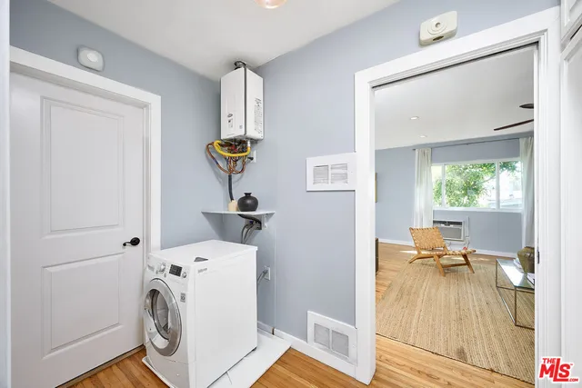 a view of living room with furniture and a mirror