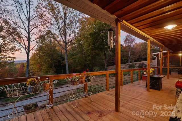 an aerial view of residential house with trees all around