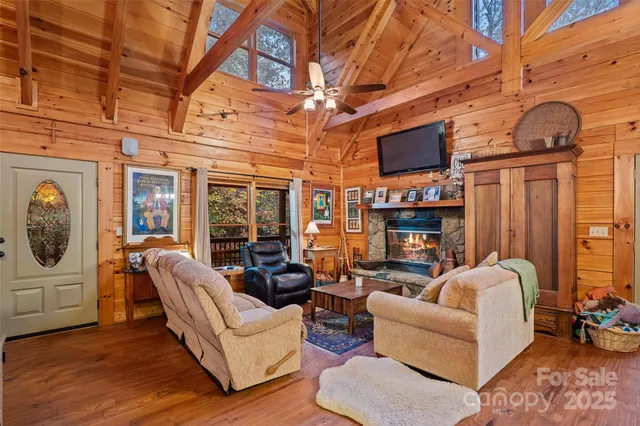 a dining room with furniture a chandelier and wooden floor