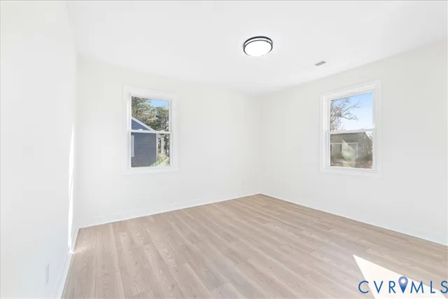 a view of a room with wooden floor and window
