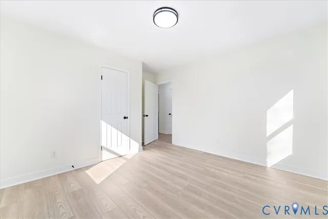 a view of room with window and wooden floor