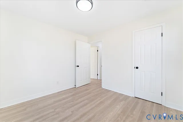 a view of a room with wooden floor