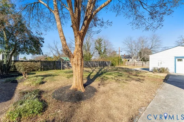 a view of a yard with snow on the road