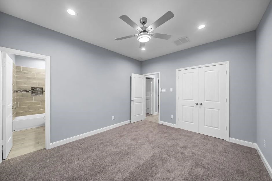 5222 Bataan Road Houston, TX 77033 - Photo 10 of 22 Beautifully designed primary suite offering generous space, modern lighting, and a peaceful ambiance.