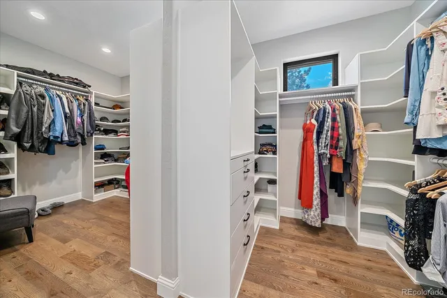 a view of walk in closet with clothes and shoes