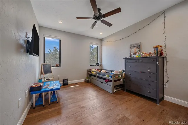a bedroom with furniture and a flat screen tv