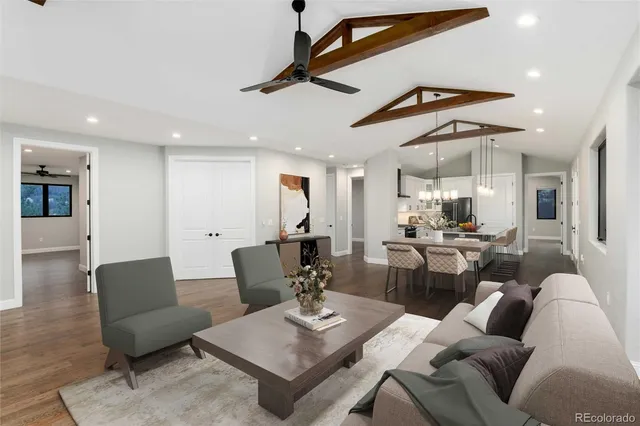 a living room with furniture kitchen view and a table