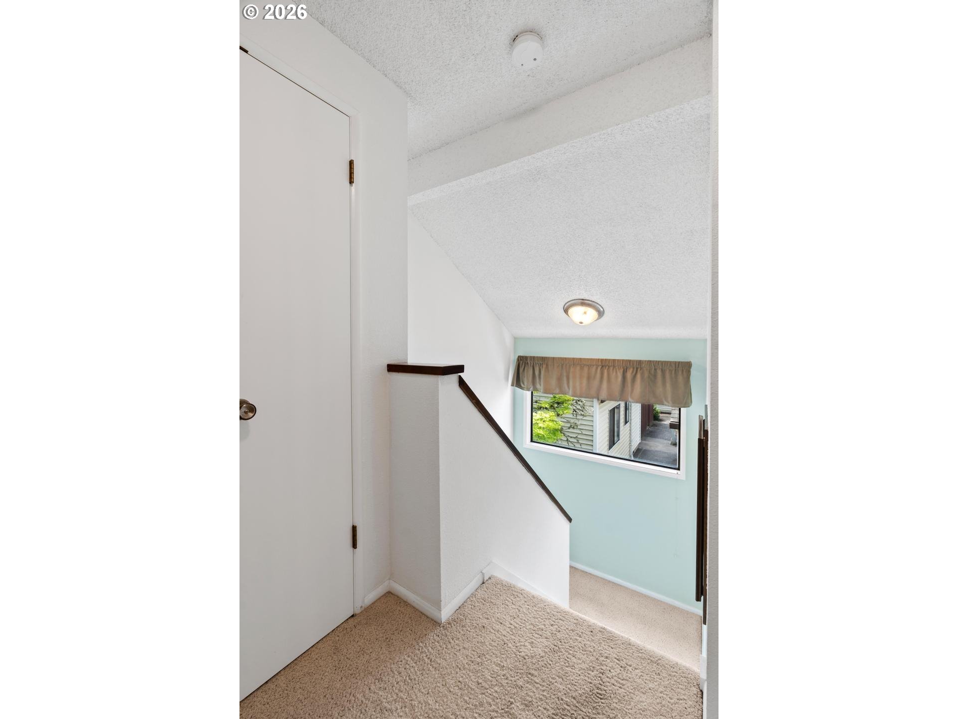 5792 Southwest 204th Place Beaverton, OR 97078 - Photo 16 of 33 a view of a hallway with wooden floor