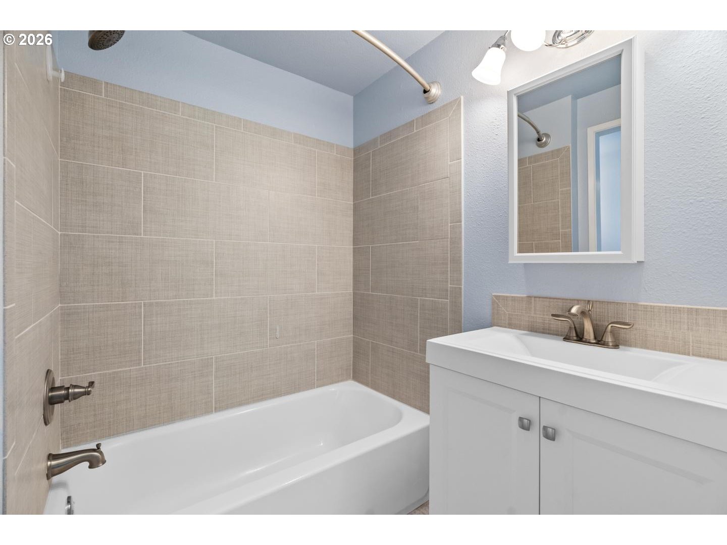 5792 Southwest 204th Place Beaverton, OR 97078 - Photo 19 of 33 a bathroom with a sink a mirror and a bathtub