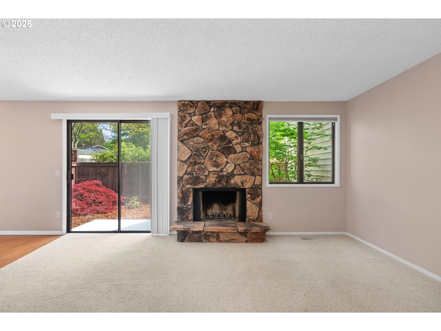 5792 Southwest 204th Place Beaverton, OR 97078 - Photo 3 of 33 an empty room with fireplace and window