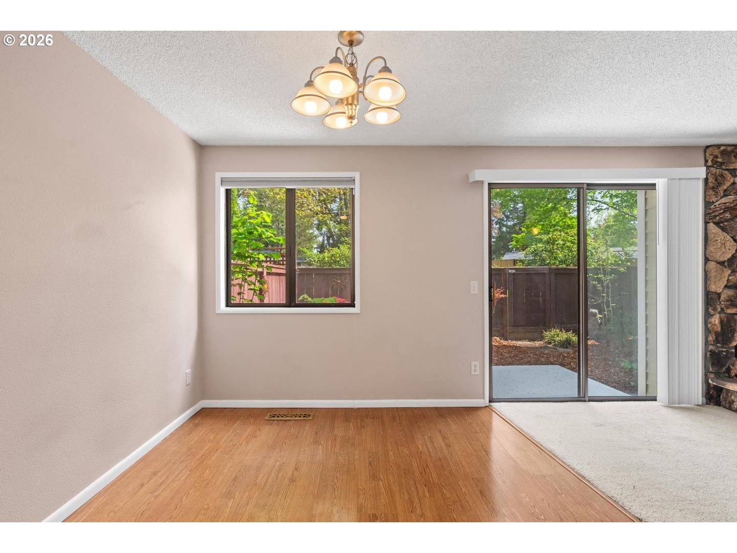 5792 Southwest 204th Place Beaverton, OR 97078 - Photo 8 of 33 an empty room with wooden floor and windows