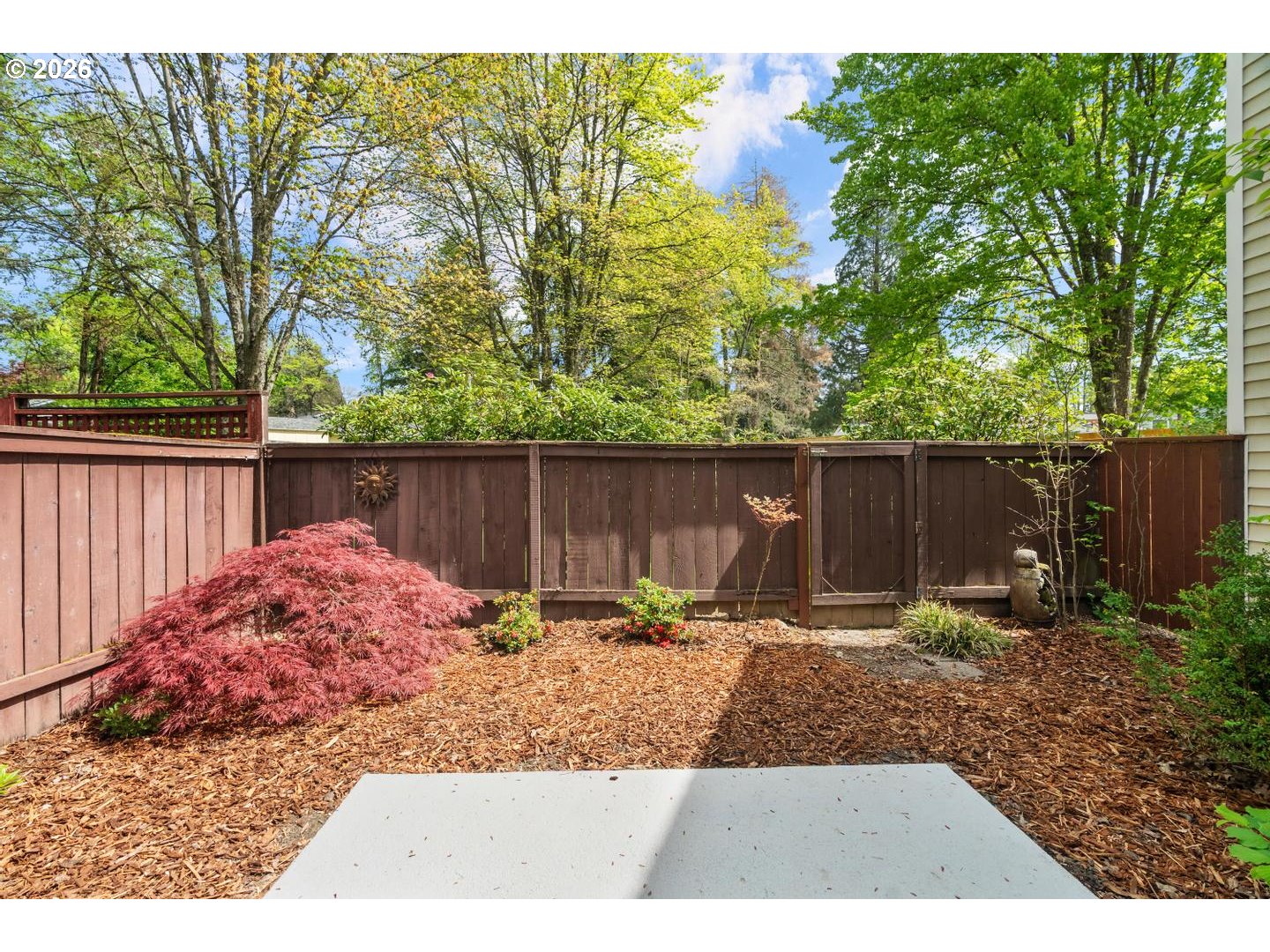 5792 Southwest 204th Place Beaverton, OR 97078 - Photo 9 of 33 a backyard with wooden fence and a bench