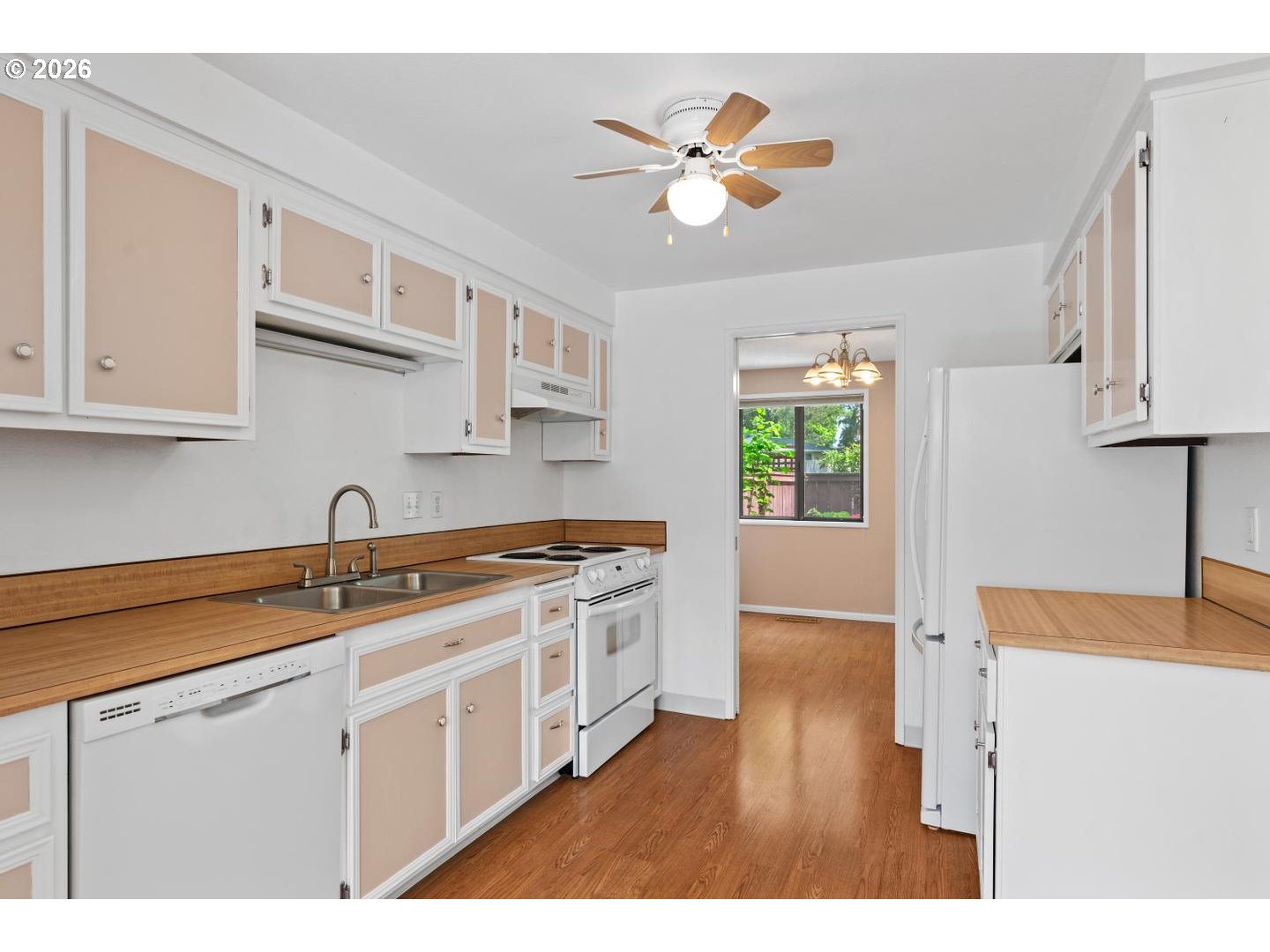 5792 Southwest 204th Place Beaverton, OR 97078 - Photo 10 of 33 a kitchen with a stove a sink a window and cabinets