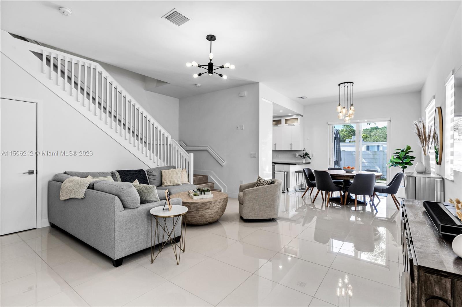 3916 Southwest 69th Avenue Miami, FL 33155 - Photo 4 of 7 a living room with furniture and a chandelier