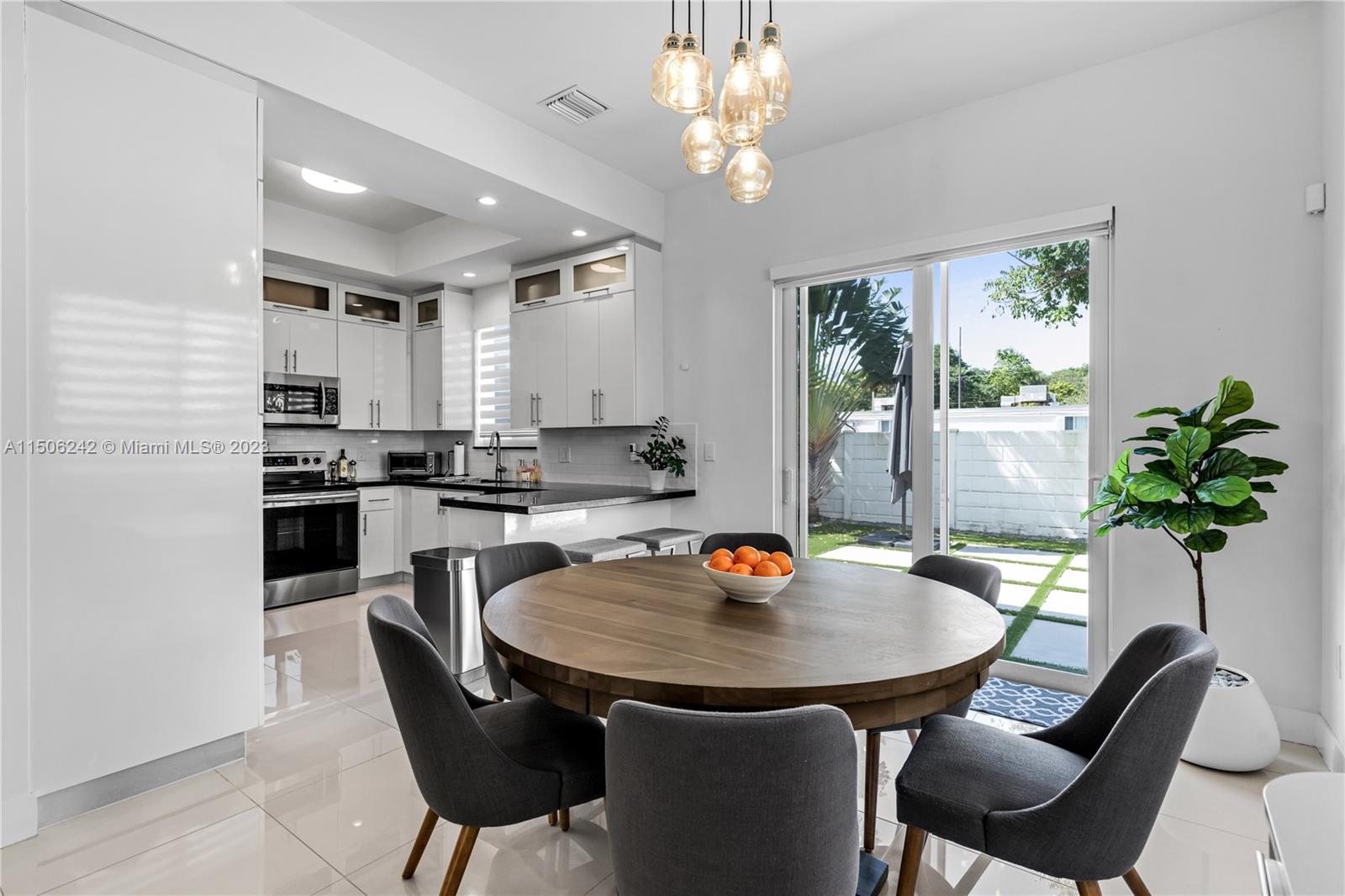3916 Southwest 69th Avenue Miami, FL 33155 - Photo 5 of 7 a kitchen with a table chairs a sink and cabinets