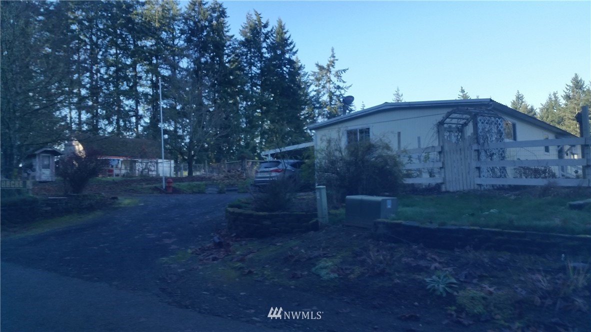 224 Wirta Road Winlock, WA 98596 - Photo 1 of 22 a view of backyard with barn and wooden fence
