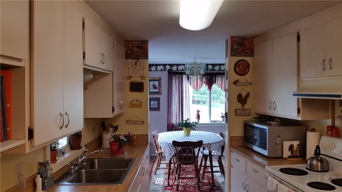 224 Wirta Road Winlock, WA 98596 - Photo 2 of 22 a kitchen with stainless steel appliances a stove a sink a refrigerator and cabinets