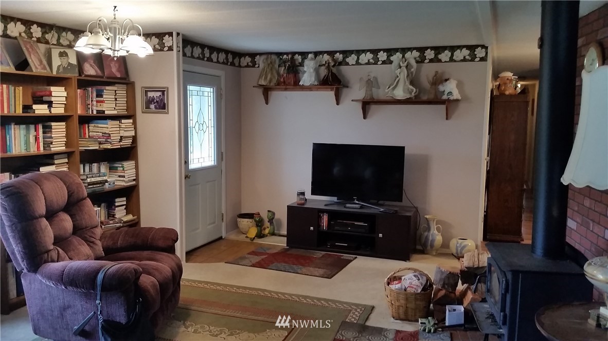 224 Wirta Road Winlock, WA 98596 - Photo 11 of 22 a living room with furniture a flat screen tv and a bookshelf