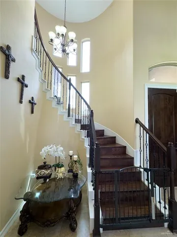 a hallway with stairs and wooden floor