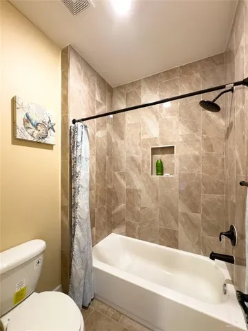 a bathroom with a toilet and a bathtub