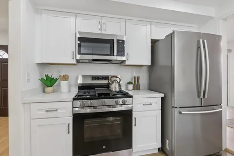 a kitchen with a sink dishwasher a stove and cabinets