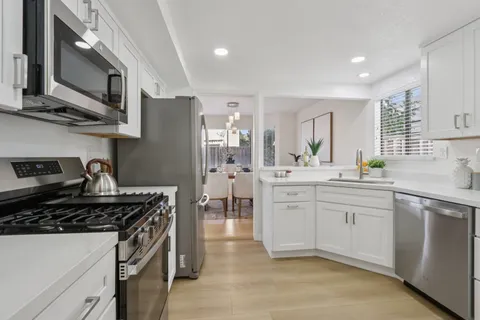 a view of a hallway with wooden floor and closet