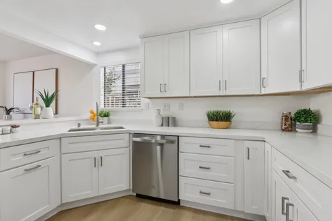 a bathroom with a sink mirror and toilet