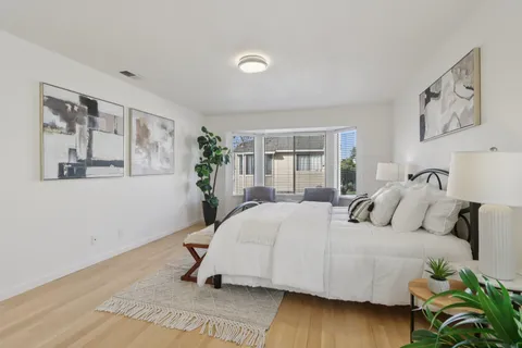 a view of a patio with couches table and chairs and potted plants