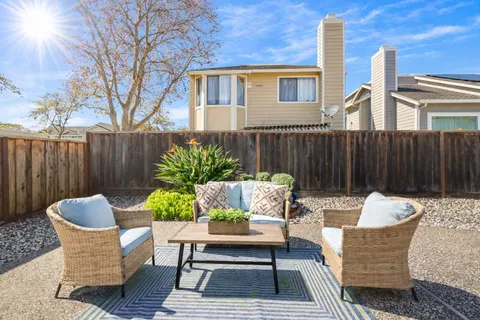 an aerial view of residential houses with yard and trees