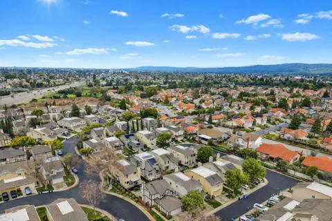 an aerial view of residential houses with yard and ocean view