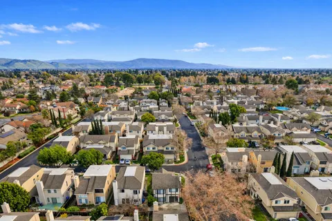 an aerial view of a house with swimming pool and garden