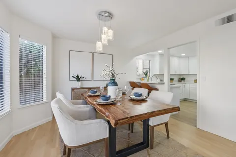 a kitchen with stainless steel appliances white cabinets white stove a microwave and a refrigerator
