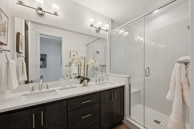 a bathroom with a double vanity sink mirror and double
