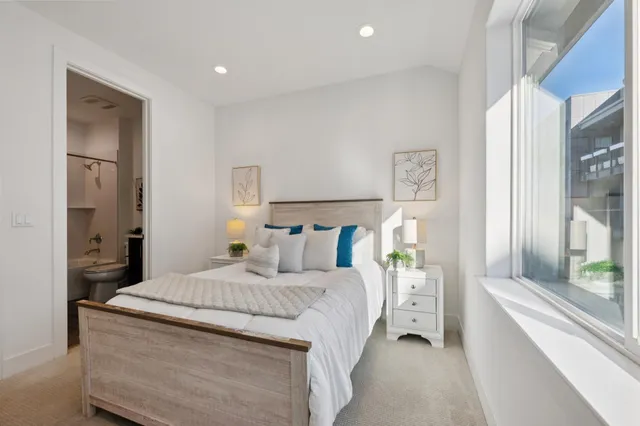 a bedroom with a large bed and a window