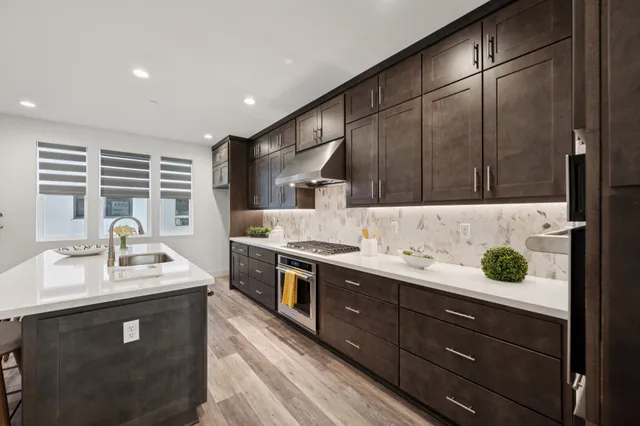 a kitchen with a sink and a stove top oven