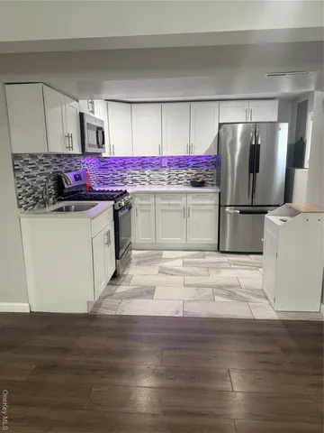 a kitchen with stainless steel appliances granite countertop a refrigerator and stove