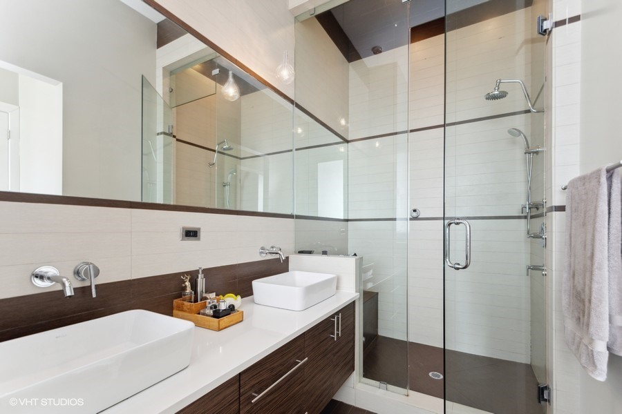 2408 West Rice Street, Unit 403 Chicago, IL 60622 - Photo 11 of 19 a bathroom with a sink and mirror