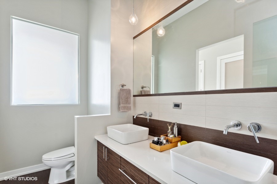 2408 West Rice Street, Unit 403 Chicago, IL 60622 - Photo 12 of 19 a bathroom with a sink and a toilet