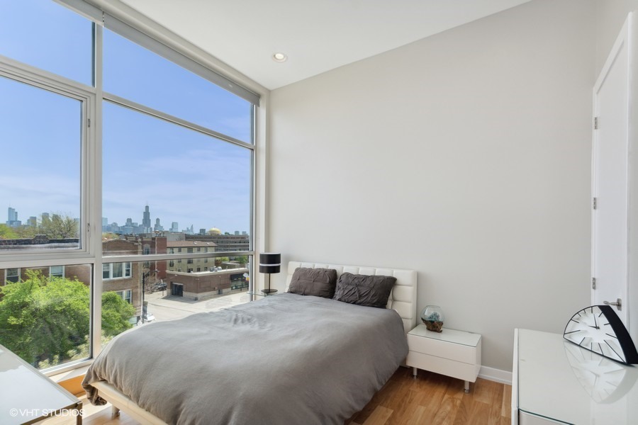 2408 West Rice Street, Unit 403 Chicago, IL 60622 - Photo 13 of 19 a bedroom with a bed and a window